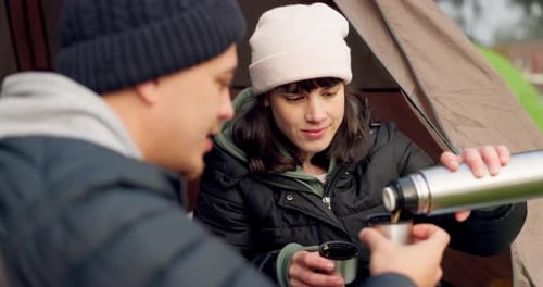 Couple Enjoying Hot Drink While Camping in Nature