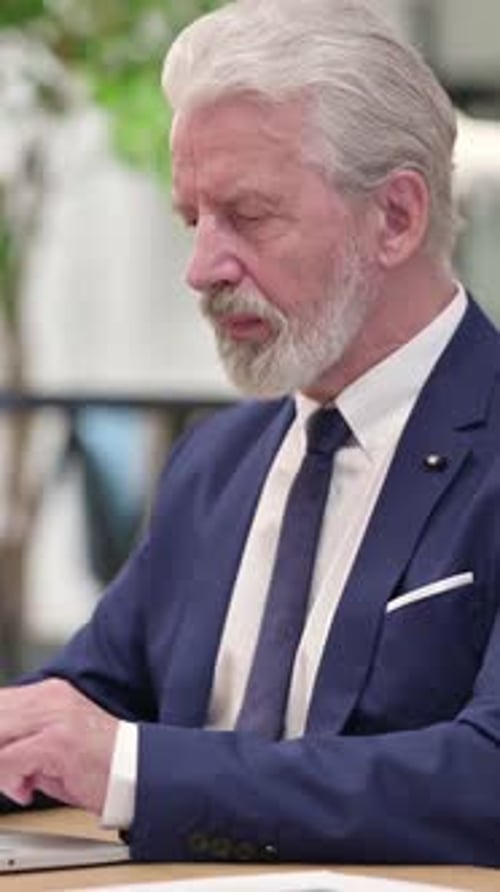 Gray Haired Man Giving a Thumbs Up