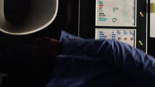 Man in Blue Suit Reviews Paperwork at Desk