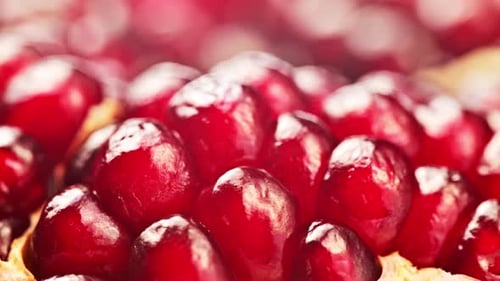 A close up of red pomegranate fruit with a lot of detail