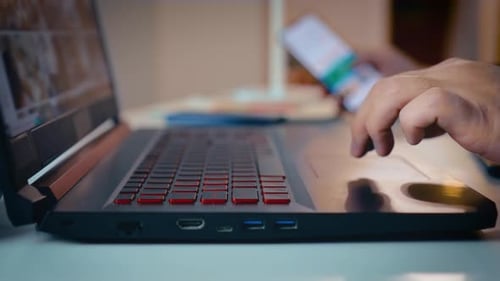 Male Hands Using Laptop Touchpad and Keyboard Close Up