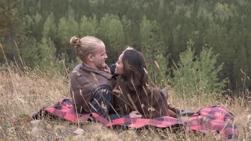 Affectionate multiethnic couple enjoys a romantic cuddle on a mountainside getaway