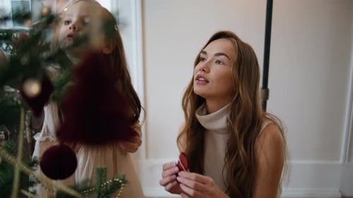 Affectionate Family Putting Xmas Toys On Branches Close Up. Cute Woman Girl Decorating Christmas ...