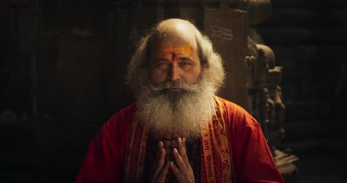 Senior Man with Beard Praying in Temple