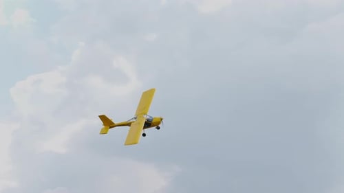 Yellow ultralight propeller plane A-22 flying sky slow motion. Flight jet A22.