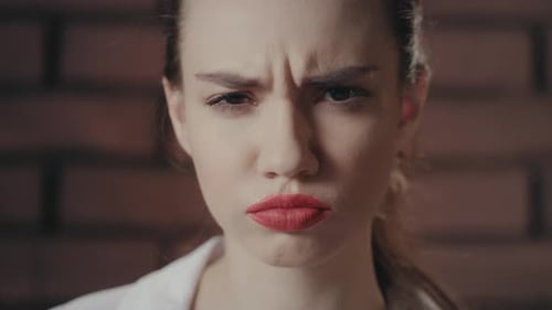 Close Up of Woman Looking Angry with Red Lips