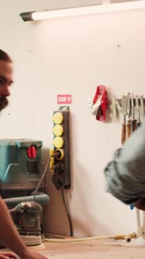 Vertical Video Manufacturer Selecting Tool From Rack to Use on Wood Materials