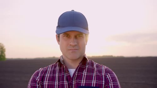 Farmer Man Portrait Looking at Camera at Field Sunset Harvesting Crop Farming