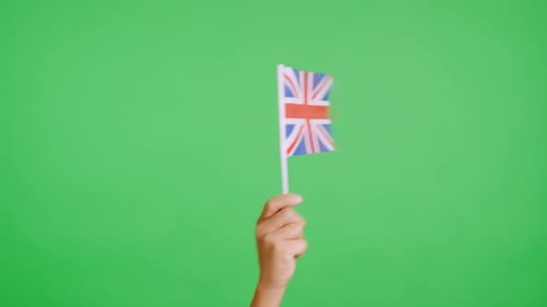 Hand Holding Union Jack Flag on Green Screen