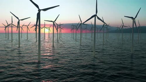 Renewable Energy Concept Wind Generators Stand in the Sea Against the Backdrop of Sunset Ecofriendly
