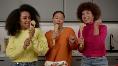 Three Friends Sing and Dance in Kitchen