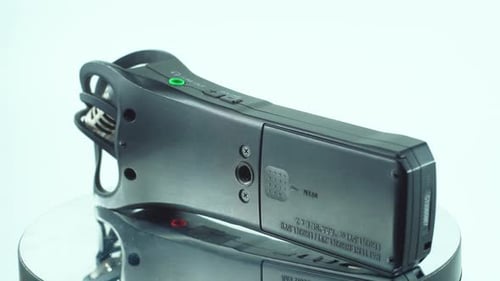 A close up shot of a handy pocket audio recorder, black sound stereophone, on a reflecting 360 rotat