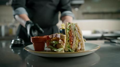 Professional kitchen in the hotel restaurant, the chef presses the bell the club sandwich is ready