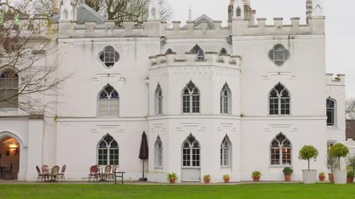 Profile view of exterior architecture of Strawberry House with garden at foreground during evening i