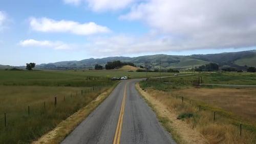 Drone Flying Above Asphalt Highway Through Fields In San Luis Obispo, California. aerial