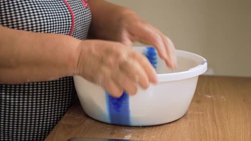 Pressing Dough Ball in Bowl with Hand Unrecognizable Person Shaping Mixture Inside Container Forming