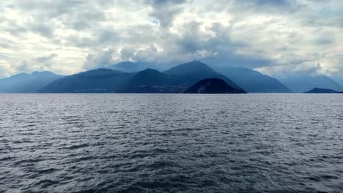 Drone shot of amazing Italian Alps and beautiful Lake Como water