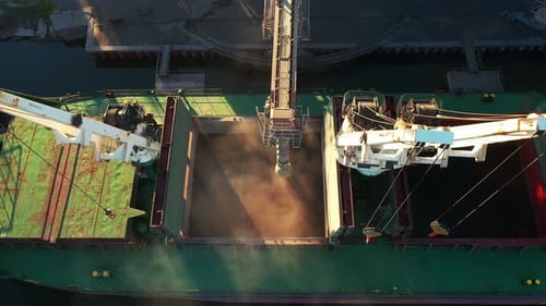 Aerial of Wheat Loading to Bulker Ship Cargo Hold at Sea Grain Elevator in Sea Port Wheat Shipment