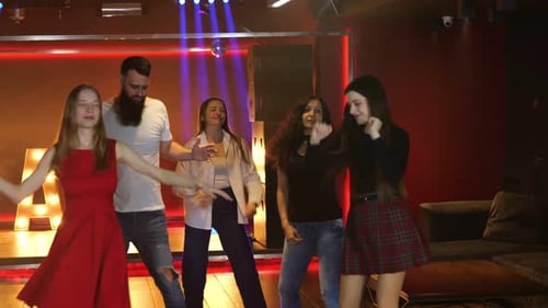 Enthusiastic Friends Dancing Together in a Nightclub