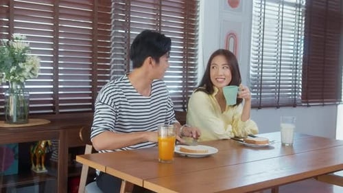 Couple Enjoying Breakfast Together Indoors