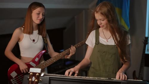 Slow Motion During a Rehearsal at a Music School One Girl Plays the Synthesizer with a Sweet Smile