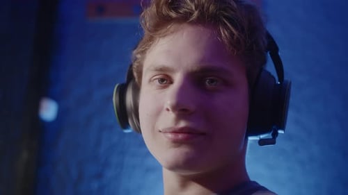 Smiling Young Man Wearing Headset in Studio