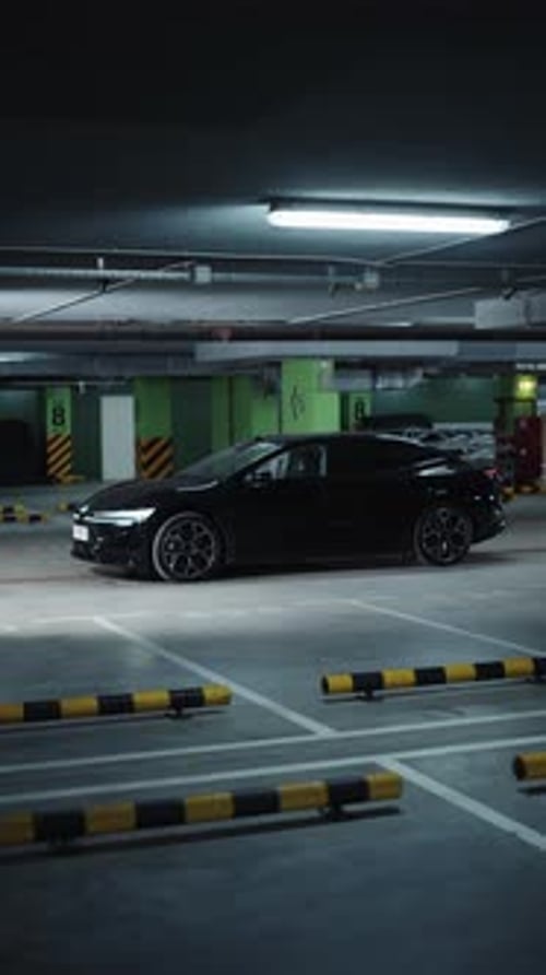 Black Electric Sedan Parked in Underground Parking Garage
