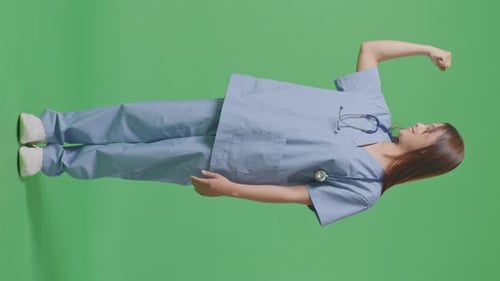 Full Body Of Asian Female Doctor With Stethoscope Smile And Flex Muscle On Green Screen