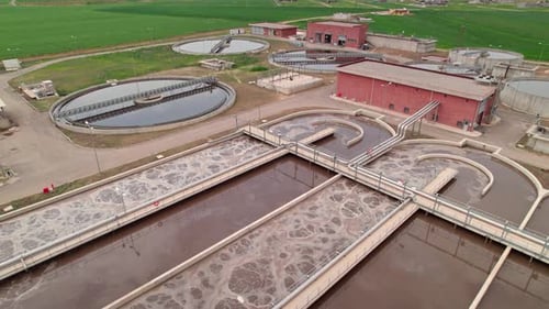 Aerial Drone View of Modern Water Treatment Plant in Green Valley, Clean Environment Concept