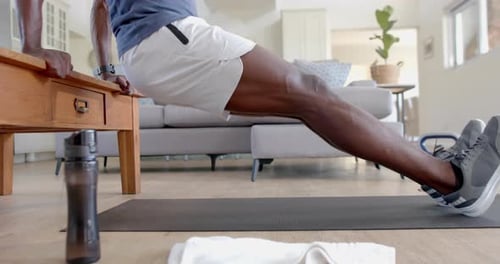 Man Doing Dips Using Table in Living Room