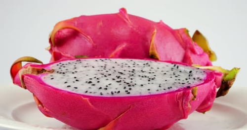 Vibrant Cut Dragon Fruit Rotating on a Plate