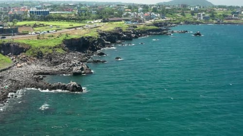 Drone view of black rocks and sea in Jeju Island.
