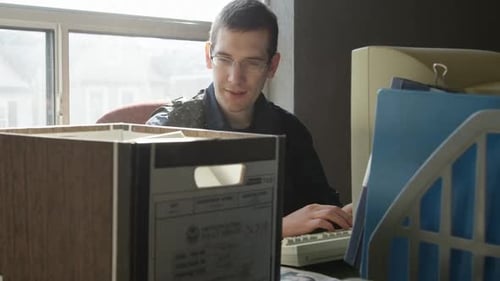 Man in Police Uniform Working at Computer