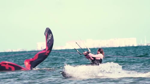 Sportsman practicing kite surf sport at the beach on a windy day at the Spanish coasts