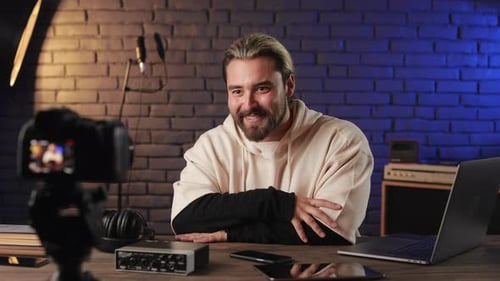 Man Filming Video Blog on Camera at Recording Studio
