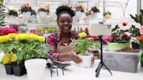 Cheerful Woman Recording Gardening Video on Mobile Phone