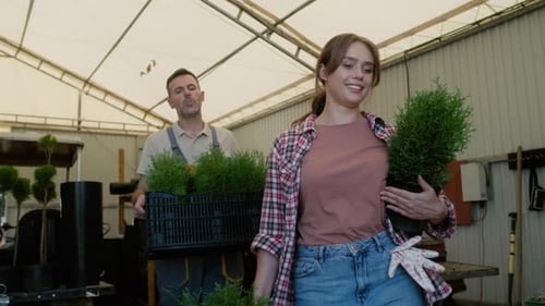 Two caucasian botanists working in plant nursery. Shot with RED helium camera in 8K.