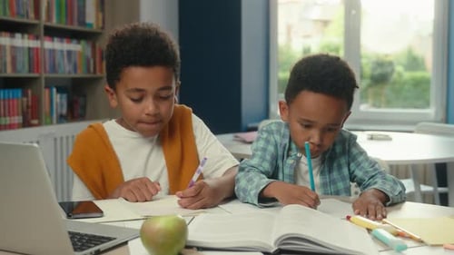 Young Students Working on Homework in the Library