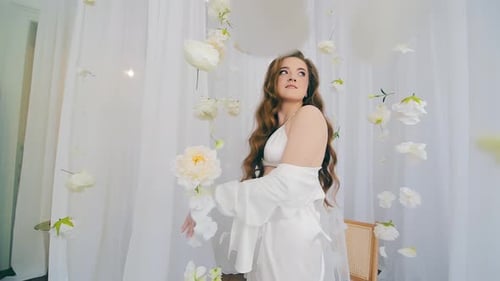 Woman in White Dress Posing near Flowers