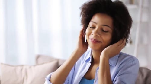 Woman Listening to Music and Dancing at Home