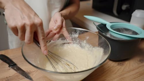 Mixing Batter in a Glass Bowl with a Whisk