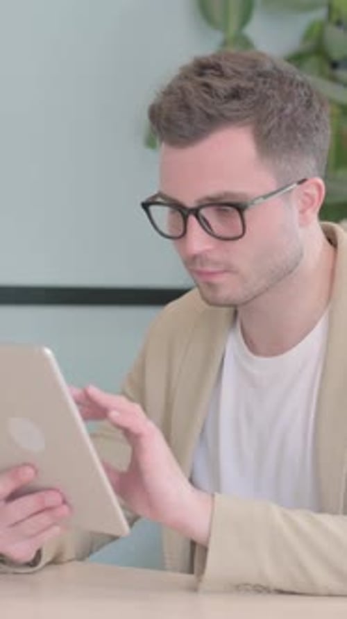 Cheerful Young Businessman using Tablet PC, Vertical Video