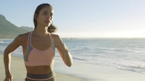 Beach, running and woman by the ocean for fitness, workout and exercise for runner health