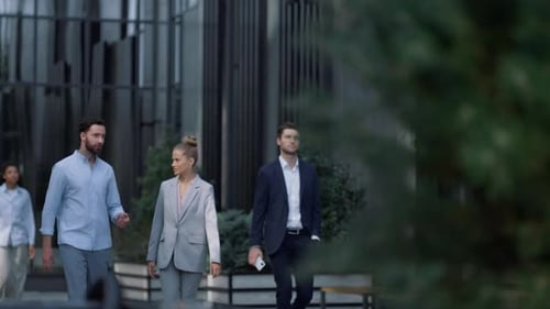 Diverse business team walking on downtown street discussing project