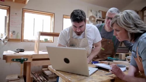 Carpenters Using Laptop in Workshop 3539 Years
