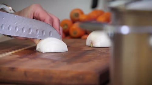 Cutting an onion on a chopping block