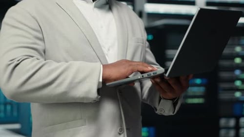 Close Up of Engineer Walking in Data Center Workplace Checking Gear
