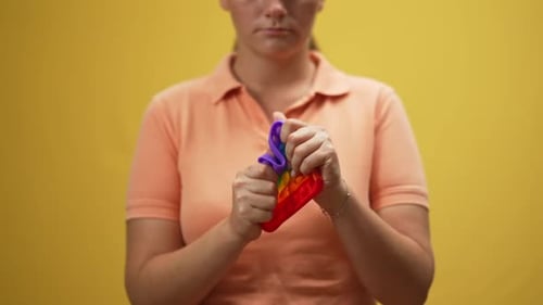 Woman Playing with Rainbow Pop-It Fidget Toy