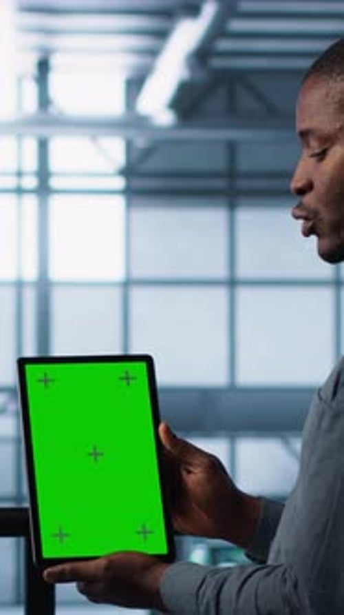 Young Adult Holding Tablet with Green Screen Talking