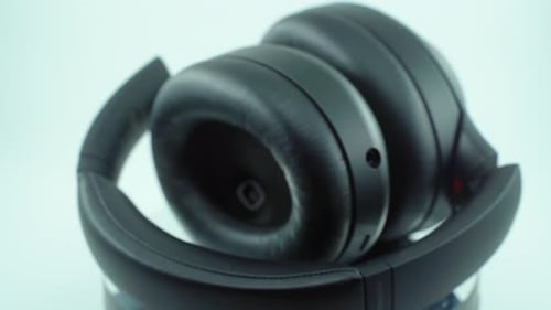 A cinematic close up shot, product 4K video, black wireless headphones set, soft earphones, studio l